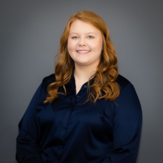 Young red haired woman wearing navy blue shirt