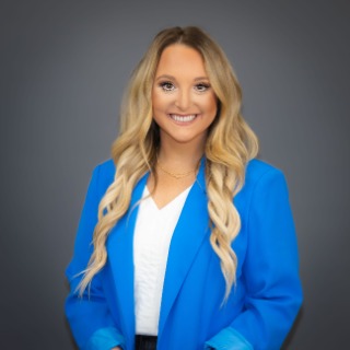 Young blonde woman wearing a white shirt and sky-blue blazer jacket