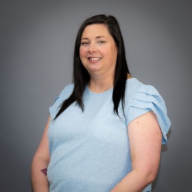 Long black-haired woman wearing a light blue blouse