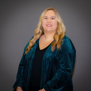 Blonde woman wearing a dark teal color shirt