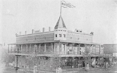 Old black and white photo of a two story hotel