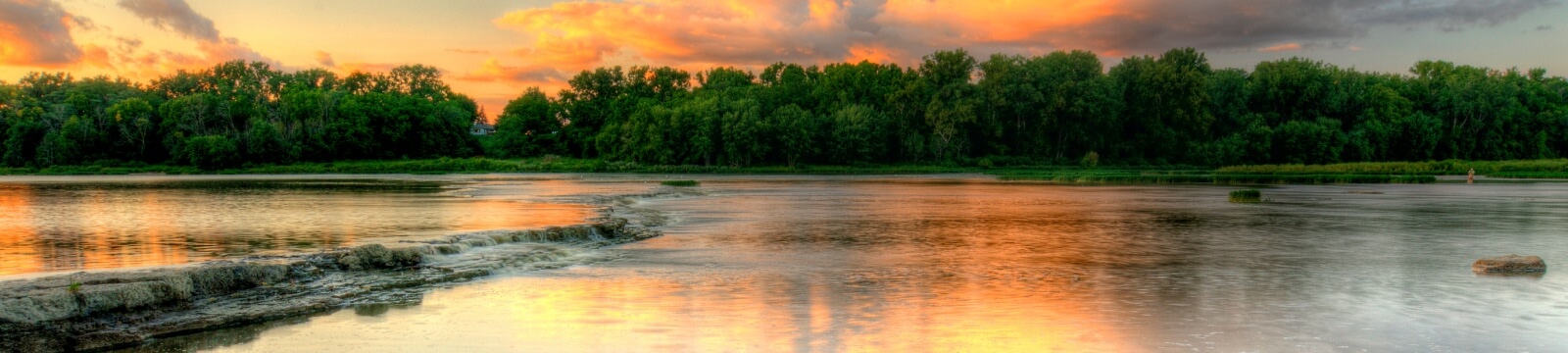 a landscape of a river and trees