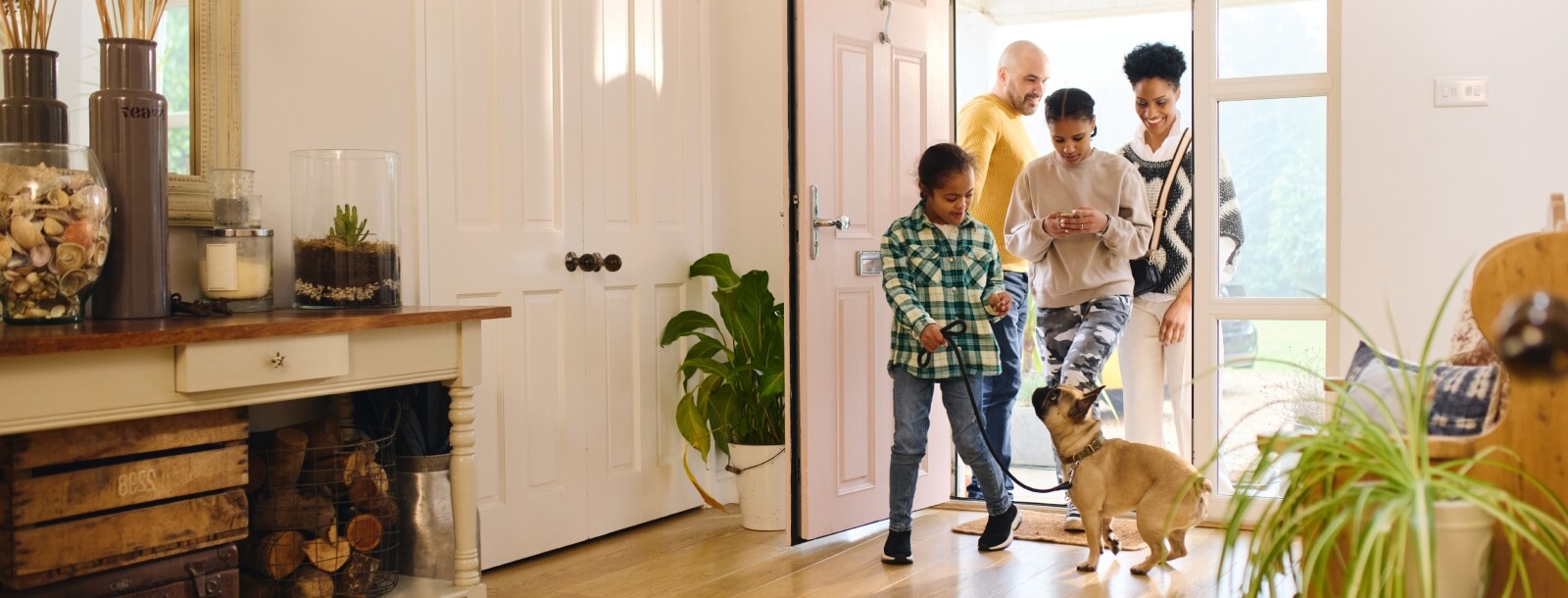 young family entering a modern home